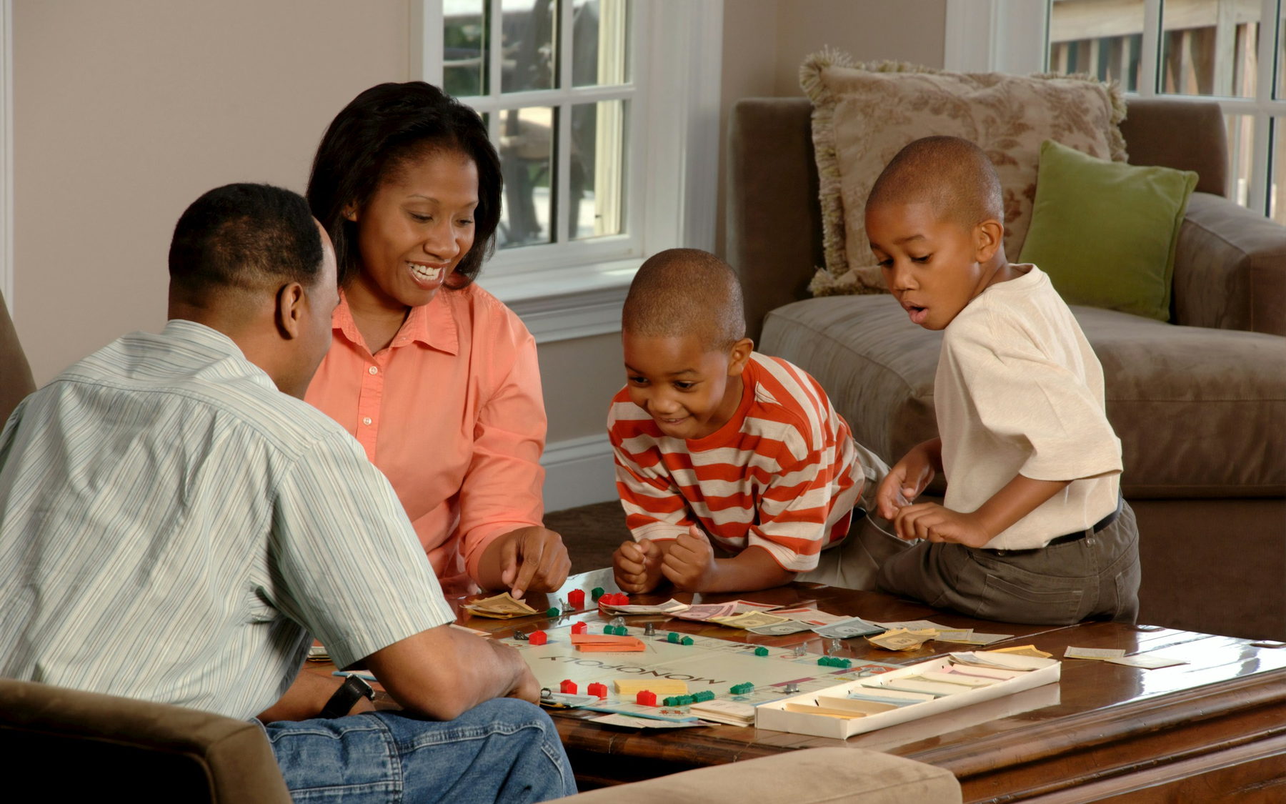 A family playing a board game together in their living room